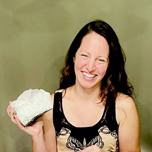 Tammy Campbell smiling and holding a large uncut gemstone