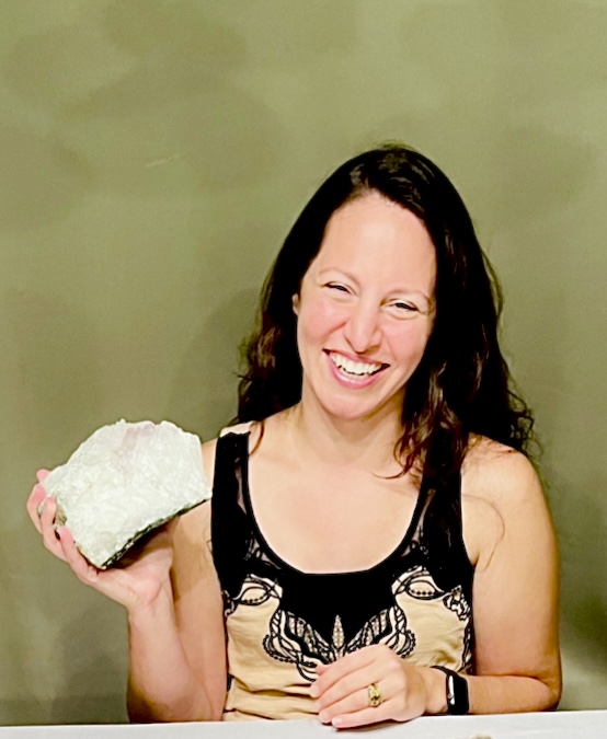 Tammy Campbell smiling and holding a large uncut gemstone