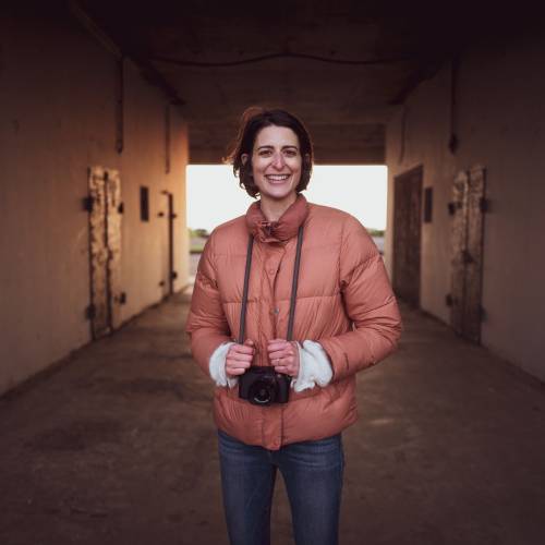 Vanessa Slavich Headshot, holding camera