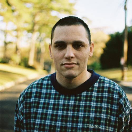 Photo of Eyal Schecter standing outside with trees in the background.