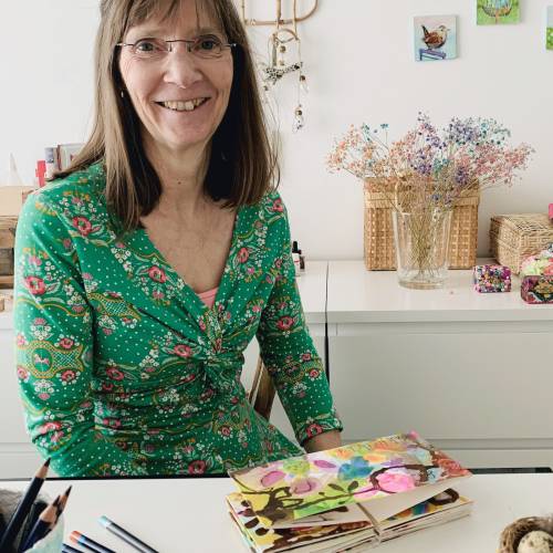 Headshot of Artist Gabrielle Heckenbucker at a desk