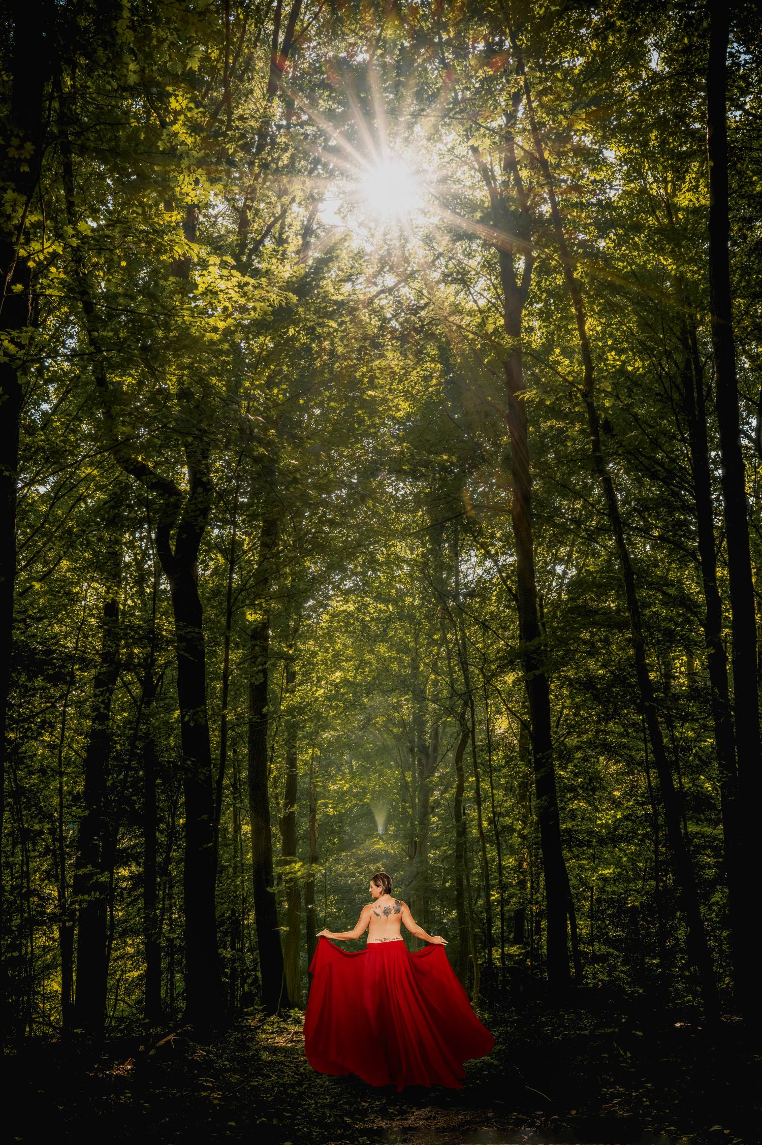 Artist Tanja Pleis' piece, "Awakening," which features Inspiration Fleurette standing in the woods, back to the camera and with a red shawl wrapped around her body.